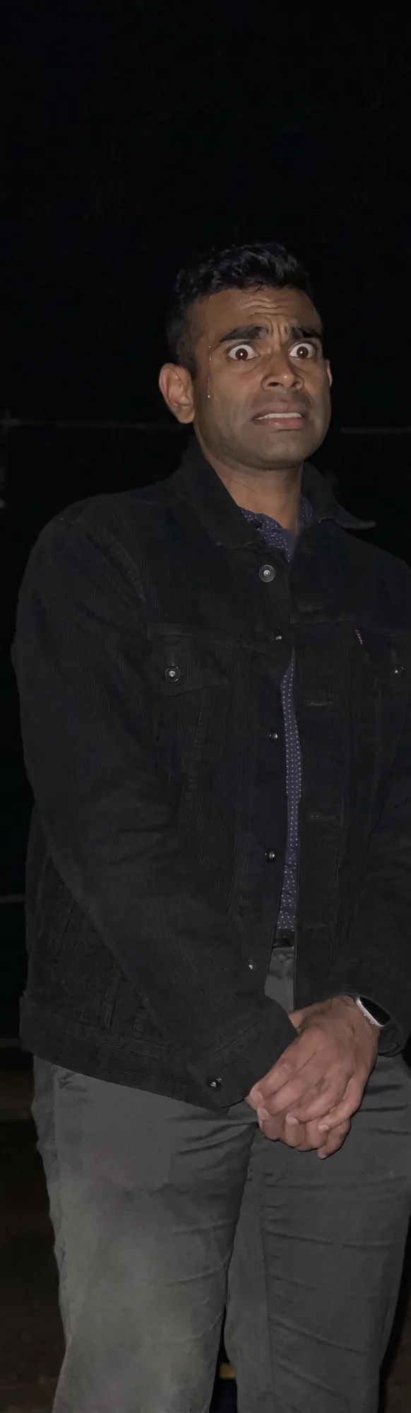 Abhijeet wide-eyed outdoors at night